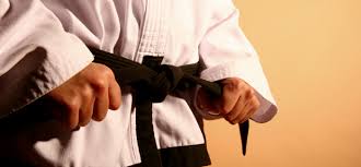 Black martial arts belt tied in a knot for training or competition.